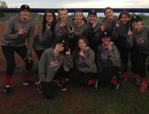 A group picture of a Leduc Minor Softball girls team showing their spirit with smiles all around