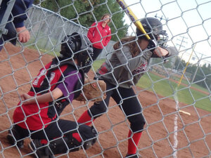 A Leduc Minor Softball game as seen from behind the backstop.